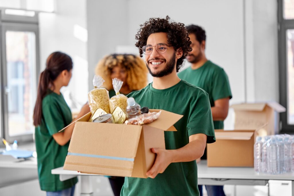 A nonprofit employee carrying a box